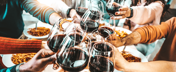 a bunch of hands clink wink glasses together