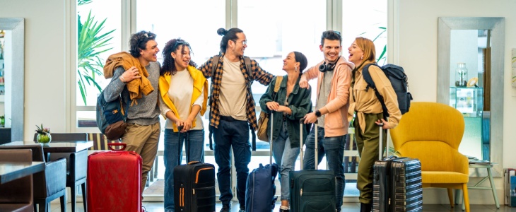 A group of friends meet up in a hotel lobby
