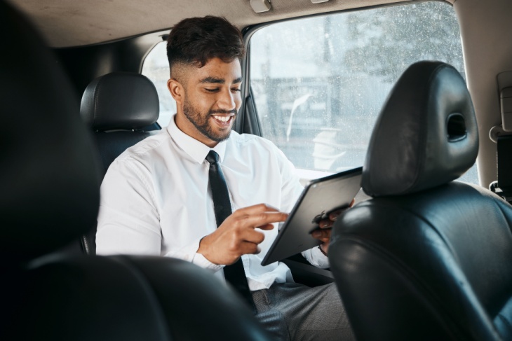 Man works on a tablet in a minibus