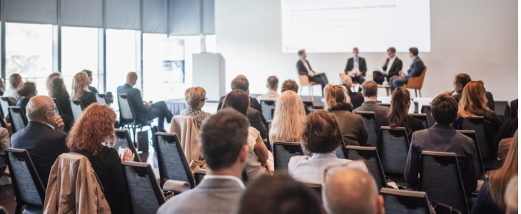 A panel of experts speak at a conference