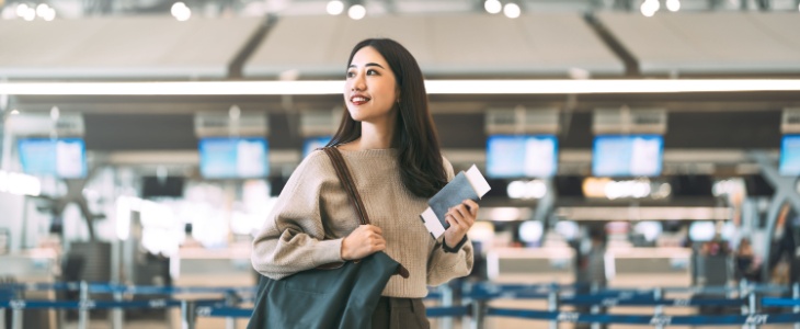 A woman looks around at an airport