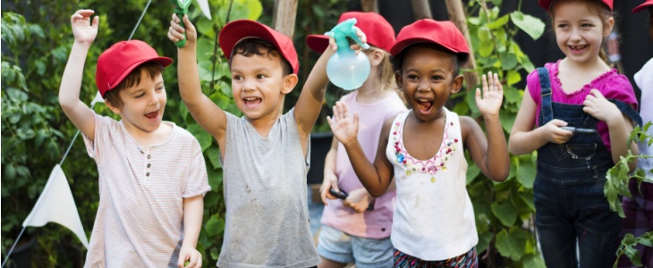 A group of children outside in matching hats