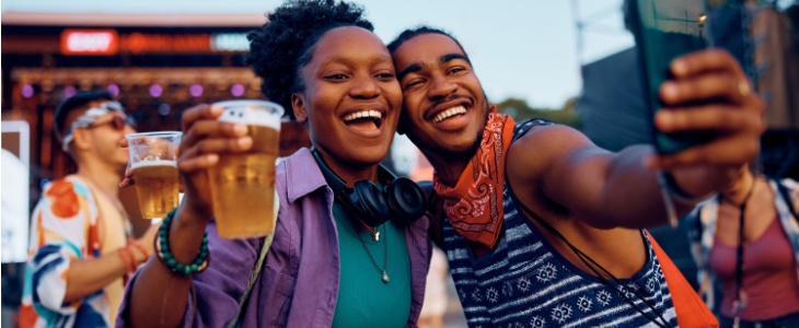 A couple takes a selfie at a festival