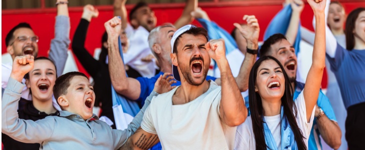 Excited sports fans cheer at a game